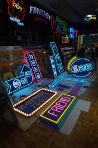 Toàn bộ cụm biển neon S26 phát sáng nhiều màu trên nền sàn xưởng